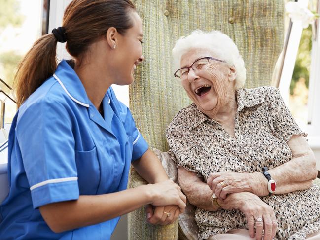 AGED CARE/NURSING HOME/SENIOR/RESIDENTIAL CARE. Picture: istock   Senior Woman Sitting In Chair And Laughing With Nurse In Retirement Home