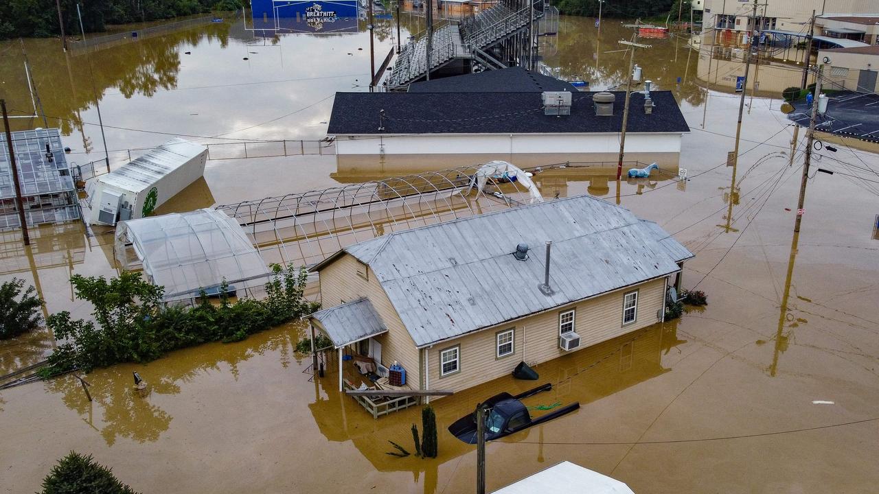 Torrential rain left some residents stranded on rooftops and in trees. Picture: AFP