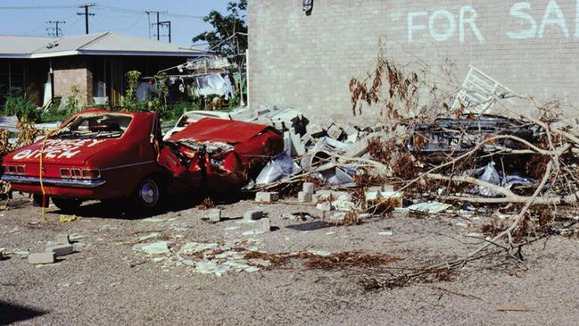 John Garner's crushed Holden Torana, emblazoned with the phrase 'Tracey [sic] You Bitch' became one of the defining images of Cyclone Tracy and its aftermath. Picture: Supplied