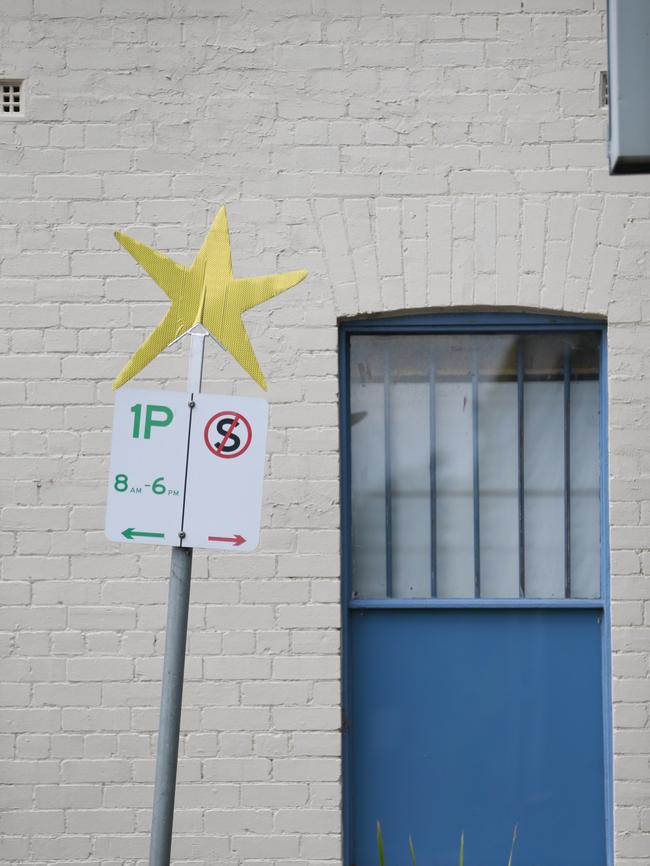 Gold stars have been stuck to signs, fences and other structures.