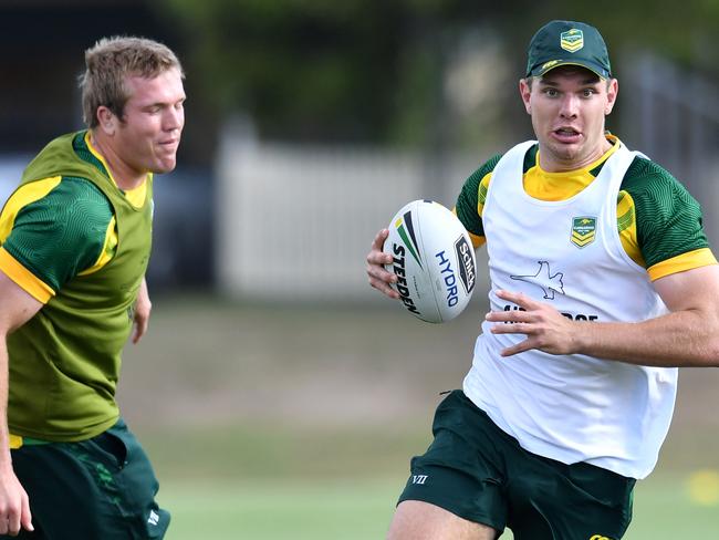 Tom Trbojevic (centre) gets past Jake Trbojevic (left) and David Klemmer (right) during training for the Australian Kangaroos NRL team at Carina Juniors Leagues Club in Brisbane, Monday, October 8, 2018. The Kangaroos are preparing for the Trans-Tasman Test against the New Zealand Kiwis at Mt Smart Stadium on Saturday. (AAP Image/Darren England) NO ARCHIVING