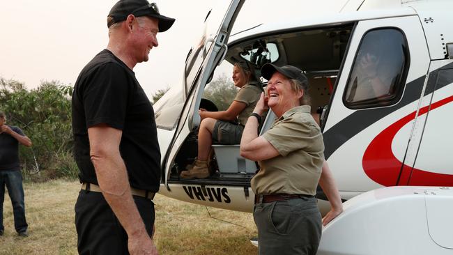 Mrs Barnard shares a laugh with Mark Harold from Sydney Helicopters after the wombats were safely on-board. Picture: Jonathan Ng