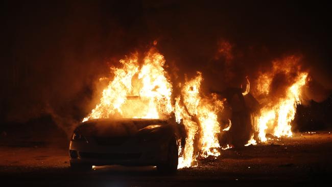 Flames roar from cars torched by protesters a few blocks from the County Court House during a demonstration against the shooting of Jacob Blake. Picture: AFP