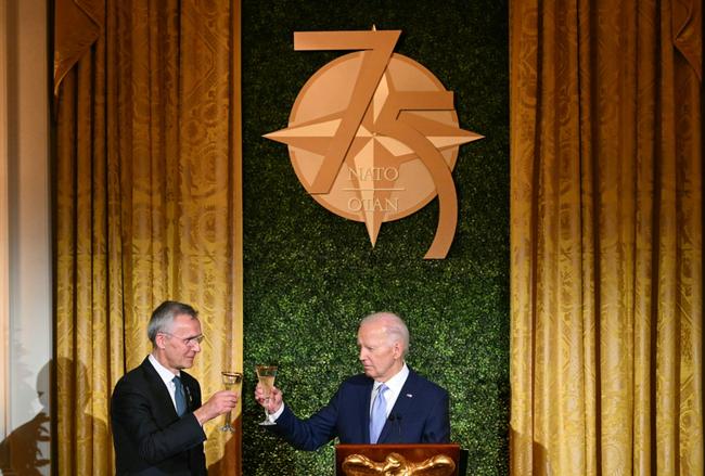 NATO Secretary General Jens Stoltenberg (L) and US President Joe Biden share a toast at a dinner with NATO allies and partners in the White House