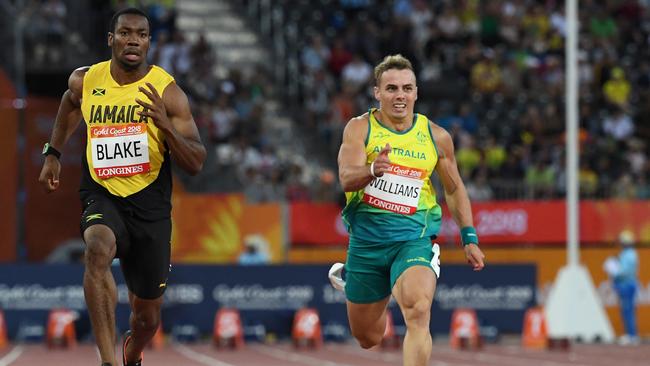 Yohan Blake of Jamaica in action ahead of Trae Williams of Australia during the mens 100m semi-final on day four of the XXI Commonwealth Games, at the Gold Coast, Australia, Sunday, April 8, 2018 . (AAP Image/Dean Lewins) NO ARCHIVING, EDITORIAL USE ONLY