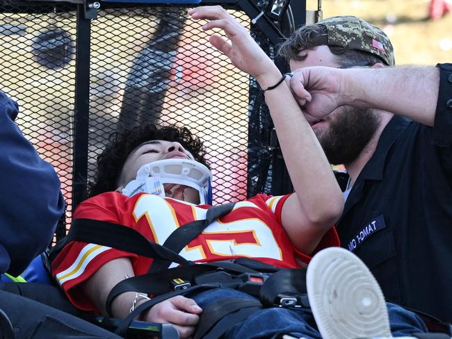 An injured person is aided near the victory parade. Picture: Andrew Caballero-Reynolds/AFP