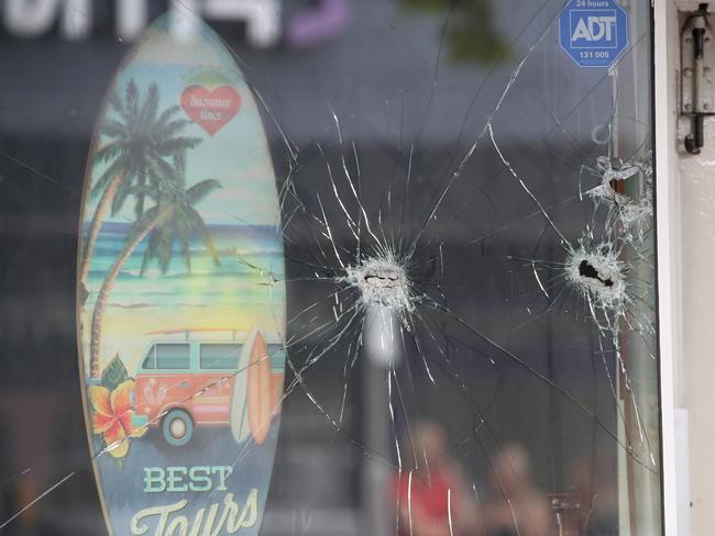 Holes in the front window of the Pier St store. Picture: David Crosling