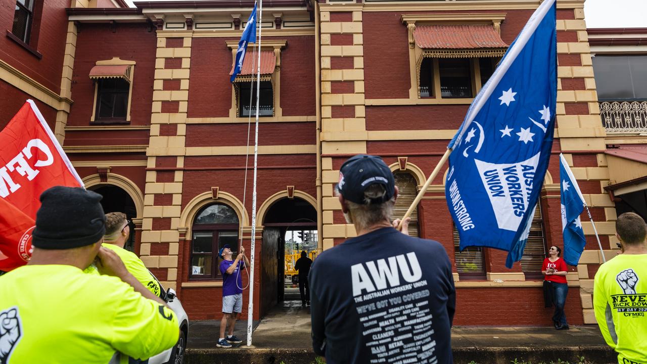 Ray Hingst raises the Eureka flag before the Labour Day 2022 Toowoomba march, Saturday, April 30, 2022. Picture: Kevin Farmer