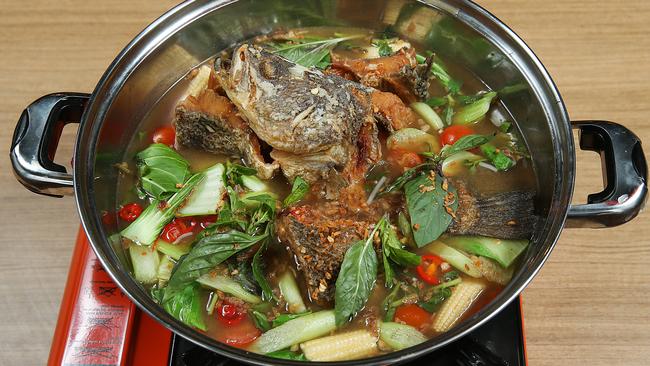 Barramundi floats in a sweet and sour steamboat. Picture: Ian Currie