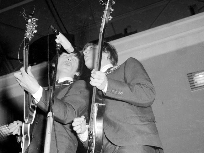 John Lennon and George Harrison on stage at Festival Hall in Melbourne. Picture: HWT Library