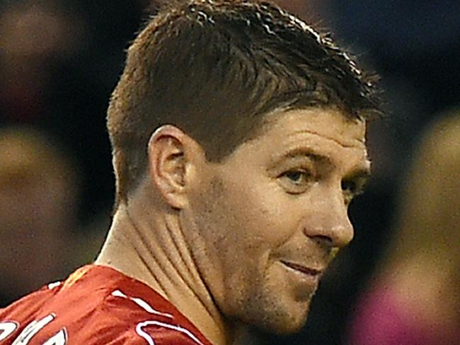 Liverpool's English midfielder Steven Gerrard celebrates scoring his second goal from a penalty during the English Premier League football match between Liverpool and Leicester City at Anfield in Liverpool, north west England, on January 1, 2015. AFP PHOTO / PAUL ELLIS RESTRICTED TO EDITORIAL USE. No use with unauthorized audio, video, data, fixture lists, club/league logos or “live” services. Online in-match use limited to 45 images, no video emulation. No use in betting, games or single club/league/player publications.