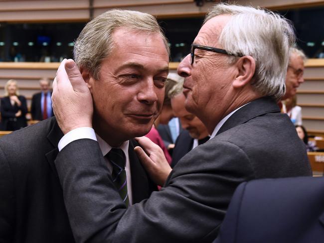 The moment between Jean Claude Juncker and Nigel Farage before the session turned nasty. Picture: JOHN THYS