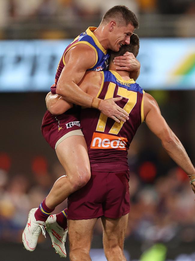 Jarryd Lyons celebrates a goal with Lions skipper Dayne Zorko.