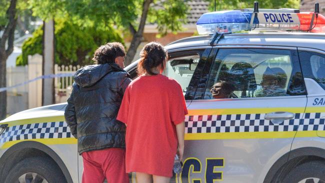 Police talk to neighbours near where the 76-year-old woman and 55-year-old man were allegedly murdered in their home. Picture: Brenton Edwards