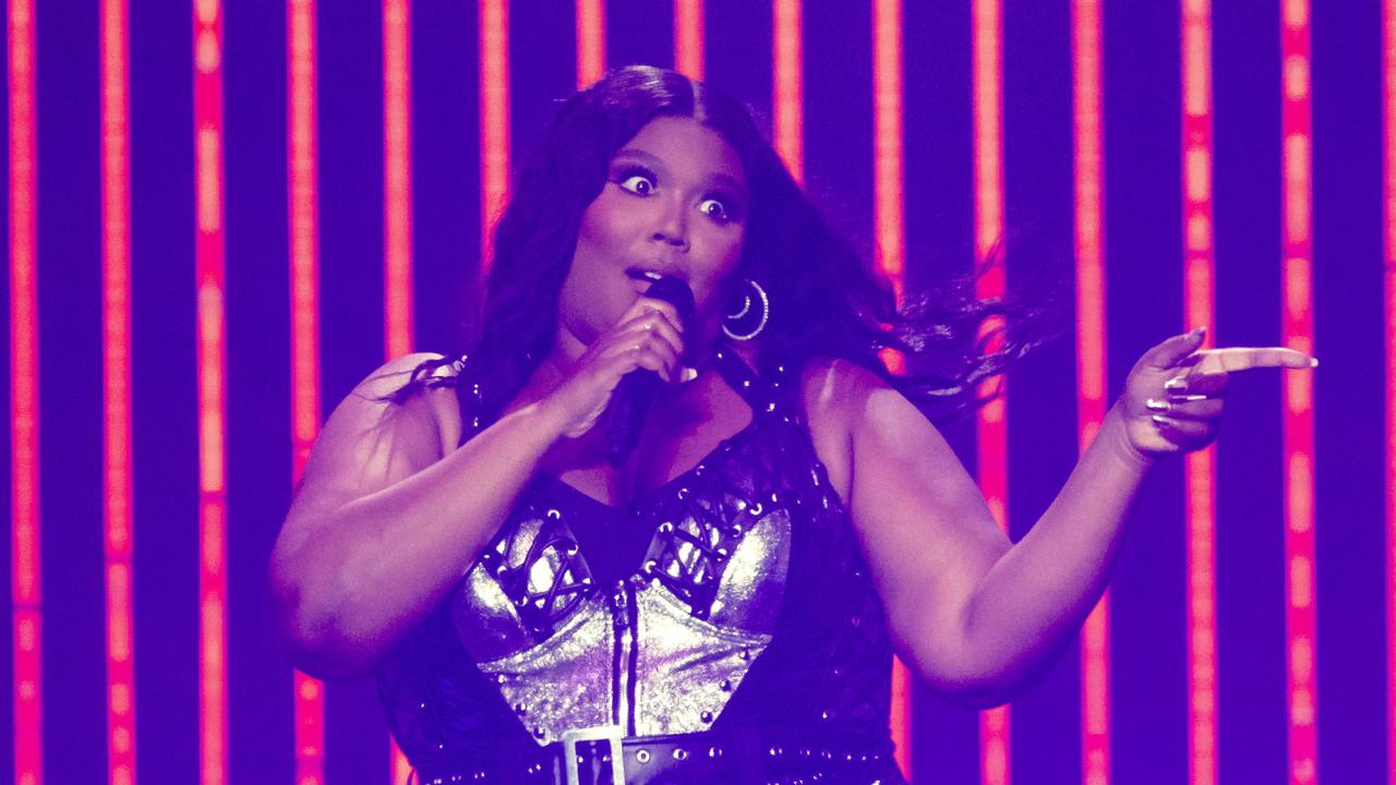 Lizzo stuns in a neon yellow nude illusion bodysuit on stage during her  Special Tour in NYC