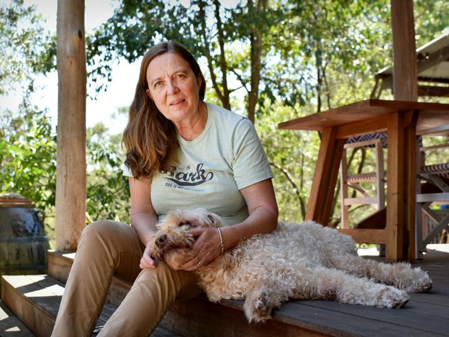 Siobhan Mahoney at home with dog Murphy in St Albans, NSW, which has been ravaged by flood and fires in the past five years. Picture: Noah Yim