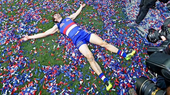 Easton Wood makes snow angels in the confetti. Picture: Tim Carrafa