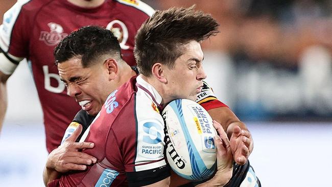 Reds' Jock Campbell is tackled by Chiefs' Anton Lienert-Brown during the Super Rugby Pacific quarterfinal match between Waikato Chiefs and Queensland Reds at Waikato Stadium in Hamilton on June 7, 2024. (Photo by DAVID ROWLAND / AFP)