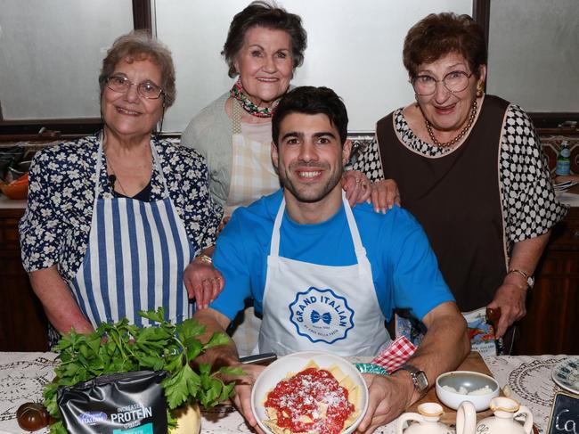 Christian Petracca with some nonnas (L-R) Connie Campori, Margeret Oldham and Vigda Bernau Picture: AFL/Anthony Licuria