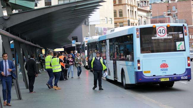 The bus stop on George St/Central Station is busier than usual due to industrial action. Volunteers have been directing the public. Picture: Christian Gilles