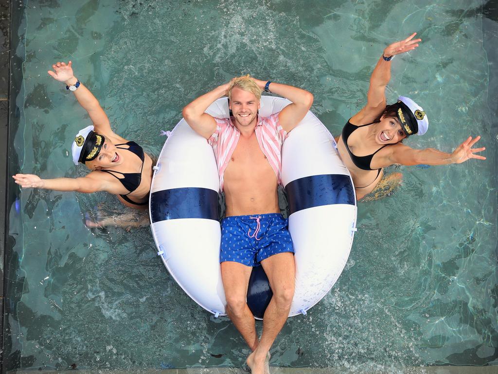 Melbourne star Jack Watts with models Alex Blakeley, and Sian Murray in the pool for Kapten &amp; Son X Skwosh collaboration. Picture: Alex Coppel