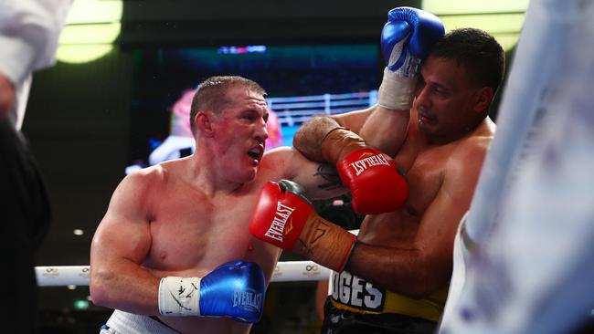 Paul Gallen punches Justin Hodges during their bout at Nissan Arena on September 15.