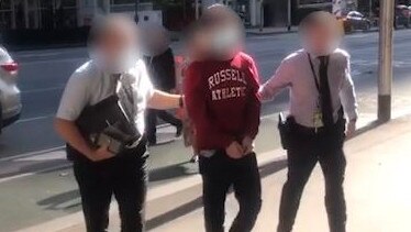 A 19-year-old Epping man, centre, who allegedly attempted to engage in a terrorist act. Picture: Victoria Police