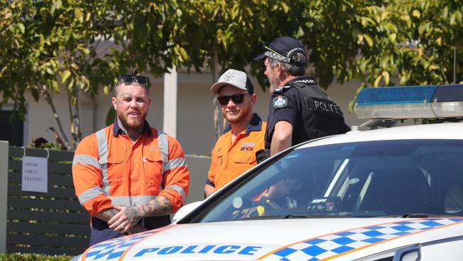 Ben Geppert (left) chatting with a police officer at the scene of the shootings. Picture: Glenn Hampson.