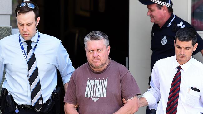 A September 20, 2016 file photo of Rick Thorburn being escorted by police from the Logan Central Police Station, Queensland. Thorburn has been sentenced to life in prison for the murder of his 12-year-old foster daughter Tiahleigh Palmer in October 2015 (AAP Image/Dave Hunt)