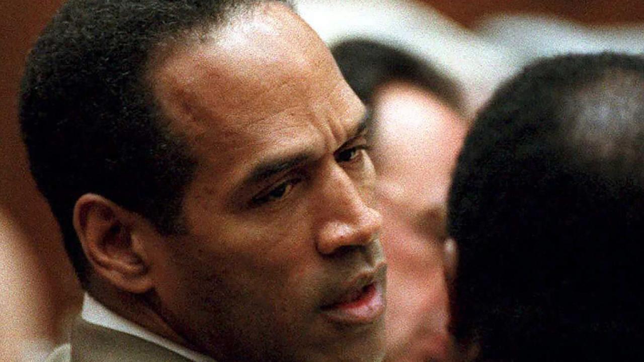 (FILES) In this file photo taken on February 15, 1995, double murder defendant OJ Simpson (L) talks to attorney Johnnie Cochran Jr., during testimony by a Los Angeles Detective Ron Phillips. - Just days after the 25th anniversary of the gruesome double murder of which he was accused but acquitted, OJ Simpson has opened a Twitter account with a vow to do "a little getting even." "Hey, Twitter world, this is yours truly," the former football star and actor says in a video that, for now, is his only post. Simpson's lawyer Malcolm LaVergne confirmed to CNN that the account was authentic, as was the video, apparently filmed by Simpson on a smartphone in the yard of a Las Vegas residence. (Photo by LEE CELANO / AFP)