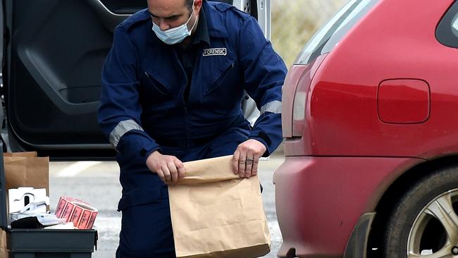 A forensic officer collects evidence. Picture: Nicole Garmston