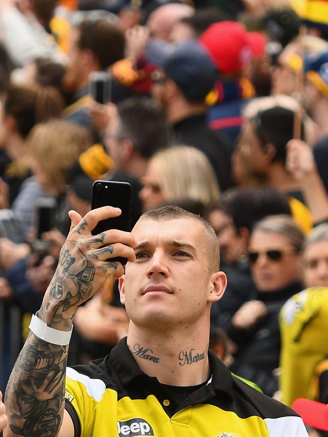 Dustin Martin takes photos of the crowd during the 2017 AFL Grand Final Parade. Picture: Getty Images