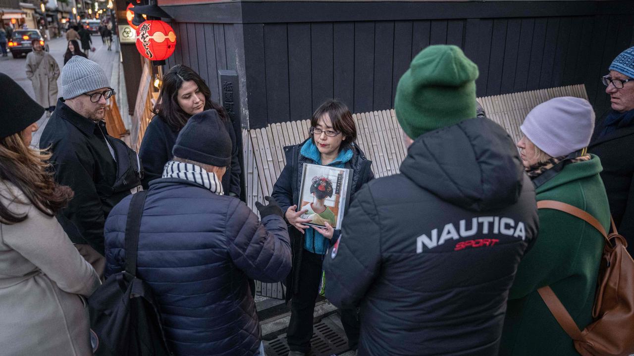 A tour guide tells tourists about geisha on Hanamikoji street in the Gion area of Kyoto in March. Picture: Yuichi Yamazaki / AFP