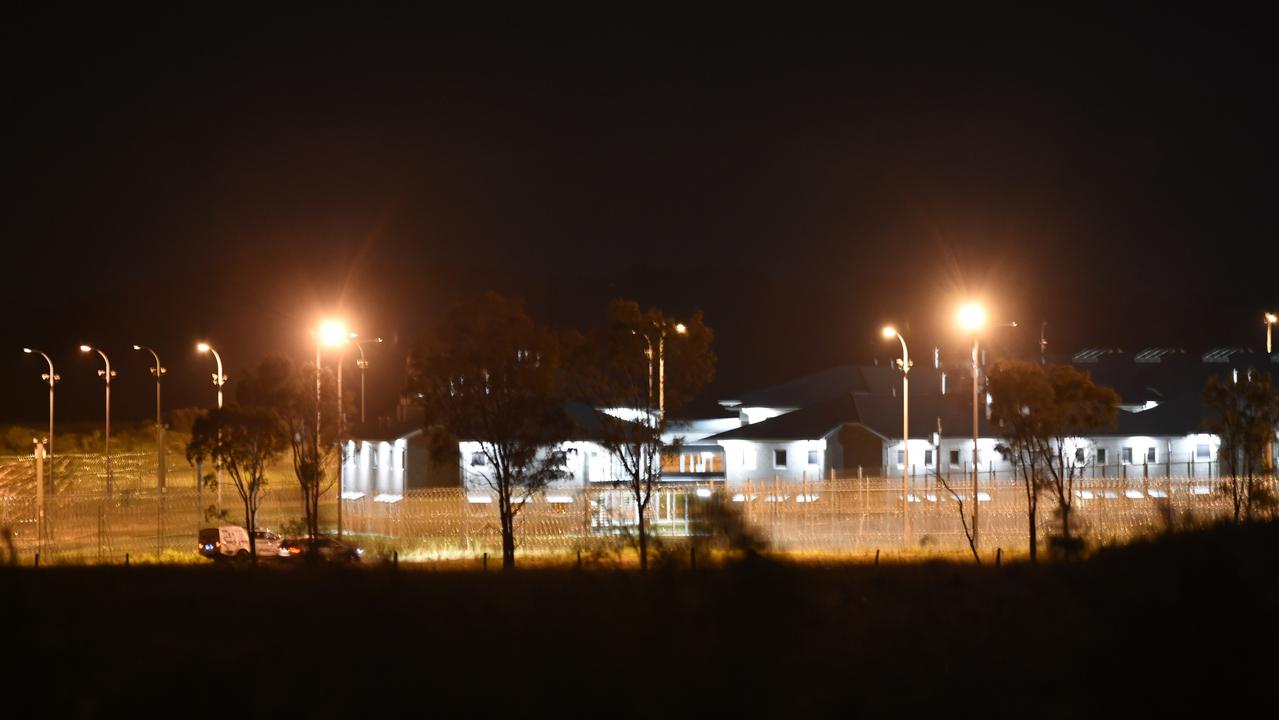 Police vehicles at the perimeter of the Capricornia Correctional Centre late on Thursday night during the riots and protests.