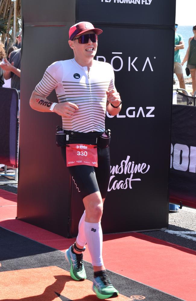 Athletes crossing the finish line at the Sunshine Coast Ironman 70.3 2023.