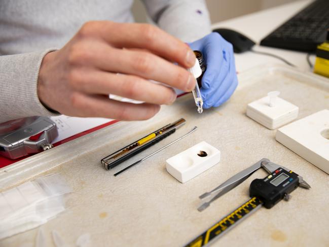 Senior Prevention worker Tom Bart with a client testing drugs in his office. Picture: Judith Jockel