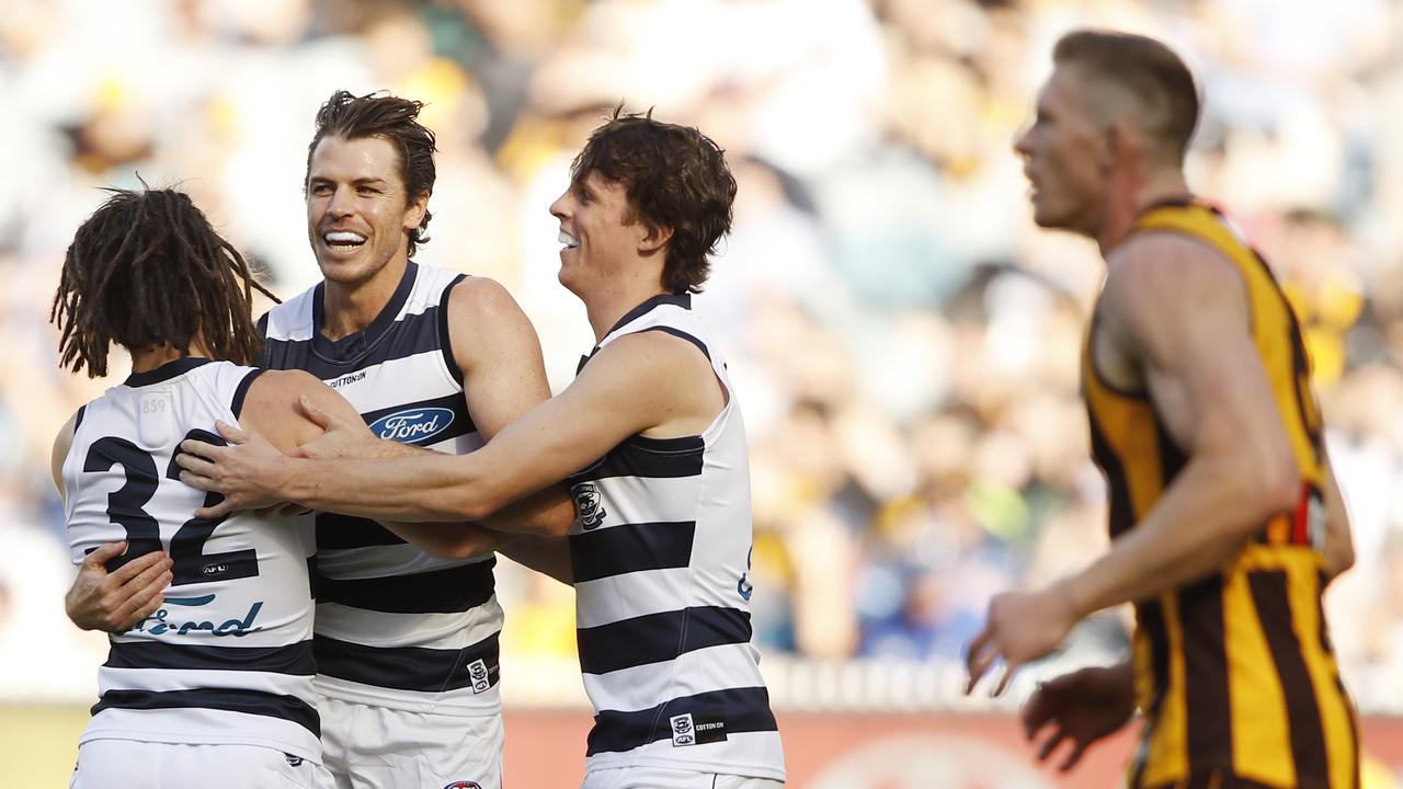 MELBOURNE, AUSTRALIA - APRIL 05: Gryan Miers of the Cats celebrates a goal with Isaac Smith and Max Holmes during the 2021 AFL Round 03 match between the Geelong Cats and the Hawthorn Hawks at the Melbourne Cricket Ground on April 05, 2021 in Melbourne, Australia. (Photo by Dylan Burns/AFL Photos via Getty Images)