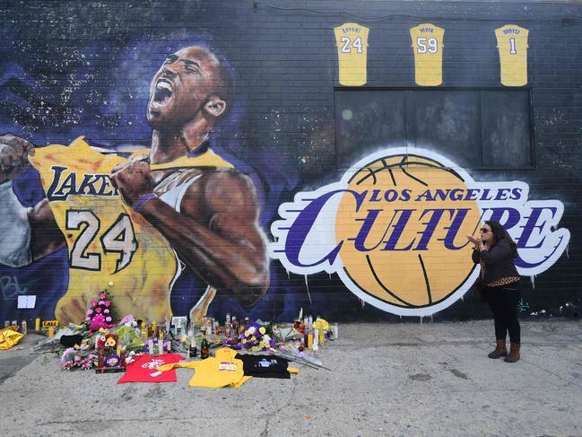 People gather in front of a Kobe Bryant mural in downtown Los Angeles. Picture: AFP