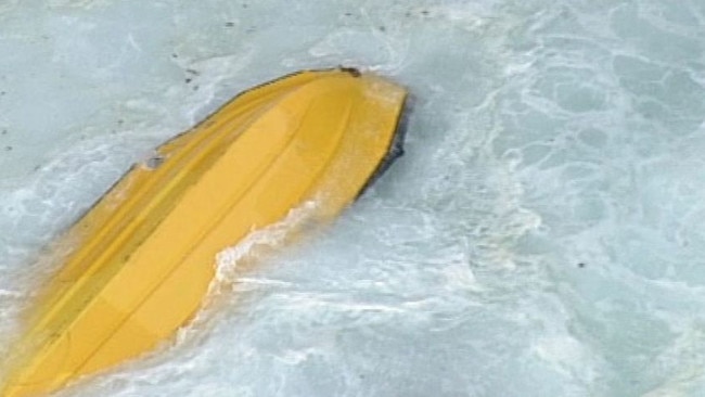 The overturned boat in the waters off Port Campbell, where the two men drowned. Picture: ABC News