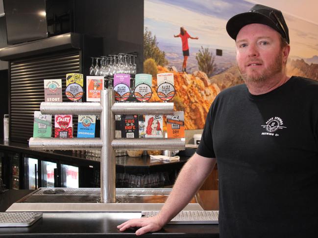 Alice Springs Brewing Co owner Kyle Pearson next to a selection of his beers at the namesake Alice Springs pub in August 2024. Picture: Gera Kazakov