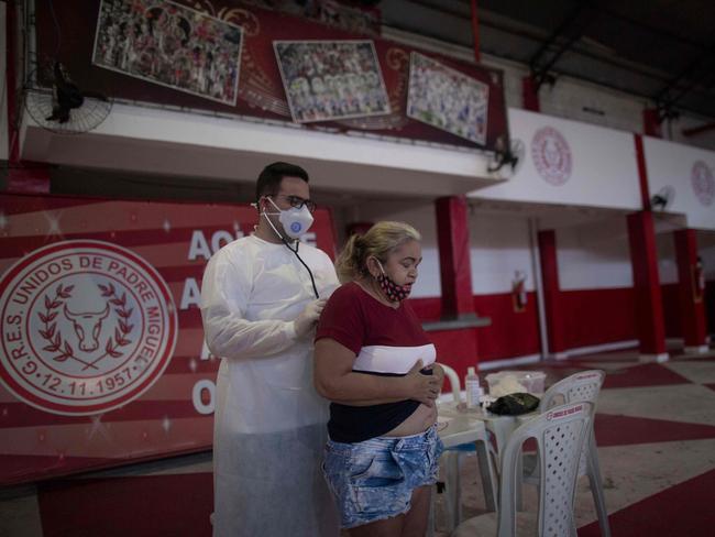 A doctor attends a woman showing symptoms of coronavirus in Rio de Janeiro. Picture: AFP