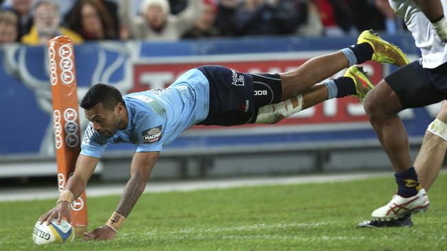 The Waratahs' Alofa Alofa dives to score a try in their Super rugby match against the Brumbies in Sydney, Australia, Saturday, June 28, 2014.(AP Photo/Rob Griffith)