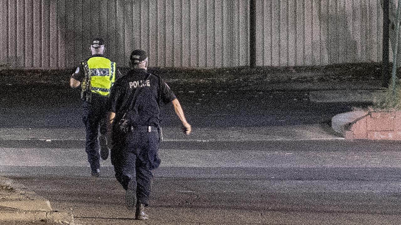 Police officers on the run chasing a group of young children on the streets of Alice Springs at night on January 26. Picture: Mark Brake