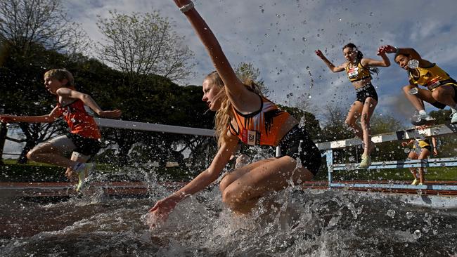 Charlee Dornom, Tilly Williams and Sarah Hastings attempt the water jump during the 2000m Steeplechase during the Athletics Victoria Shield League at Knox Athletics Track. in Knoxfield, Saturday, Oct. 8, 2022. Picture: Andy Brownbill