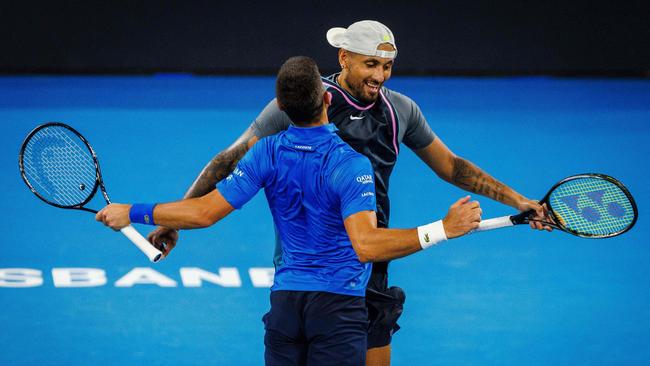 Australiaâs Nick Kyrgios (R) and Serbiaâs Novak Djokovic (L) celebrate their victory following their menâs doubles match against Austraiaâs Alexander Erler and Germanyâs Andreas Mies at the Brisbane International tennis tournament in Brisbane on December 30, 2024. (Photo by Patrick HAMILTON / AFP) / -- IMAGE RESTRICTED TO EDITORIAL USE - STRICTLY NO COMMERCIAL USE --