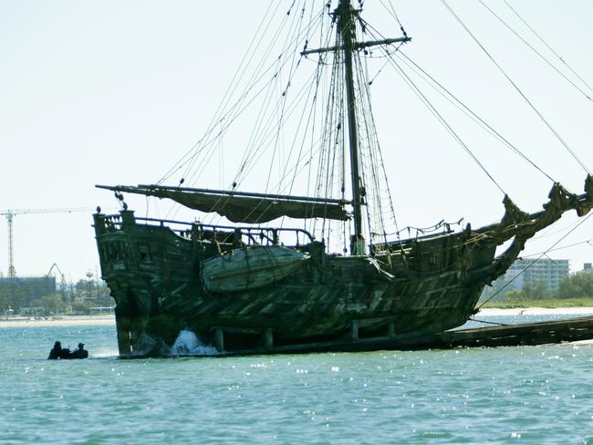 The Dying Gull runs down the beach into the water on the set of Pirates of the Caribbean: Dead Men Tell No Tales at The Spit. Two stuntmen in the water are holding a safe/chest. Pics Tim Marsden