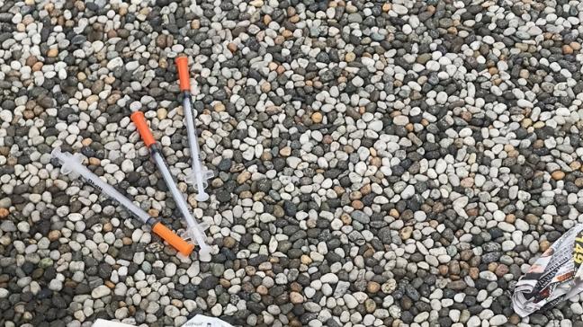 Syringes found lying outside a group of shops in Blackburn.