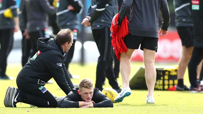 Adam Treloar receieves some attention from the trainer at Magpie training. Will he get even more from Bomber tagger Dylan Clarke? Picture: Kelly Defina/Getty