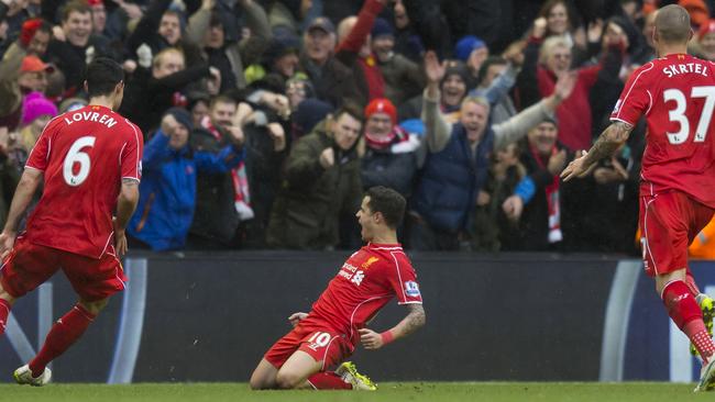 Liverpool's Philippe Coutinho, centre, celebrates after scoring.