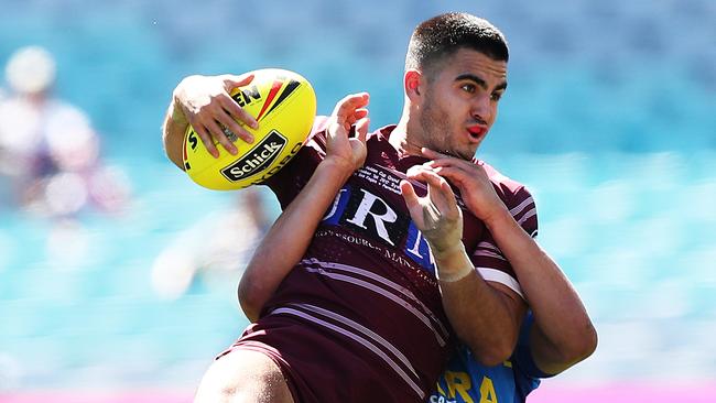 Manly's Tom Wright is tackled by Parramtta's Dylan Brown during the Parramatta Eels v Manly 2017 Holden Cup U20's Grand Final at ANZ Stadium, Sydney. Picture: Brett Costello